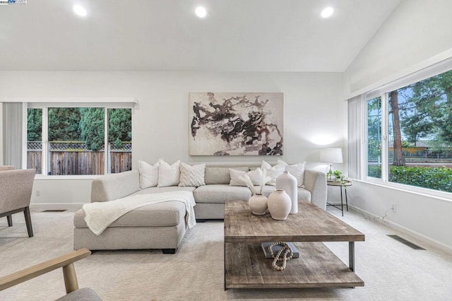 carpeted living room featuring lofted ceiling