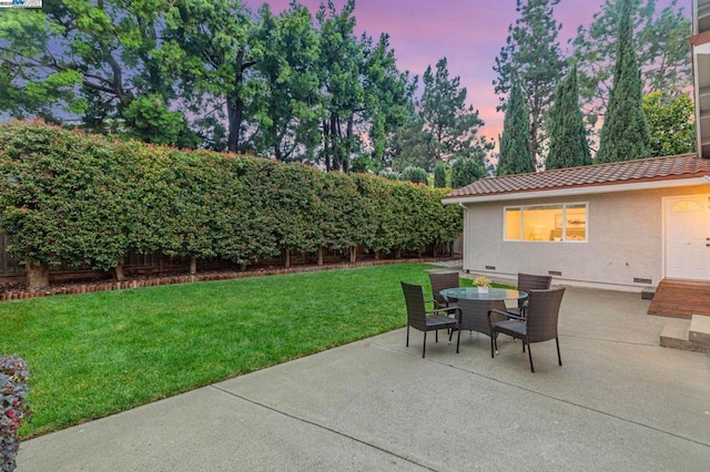 patio terrace at dusk with a yard