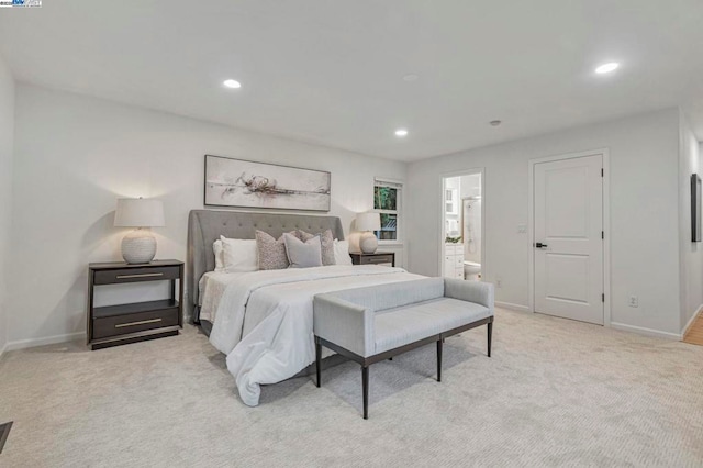 carpeted bedroom with ensuite bath