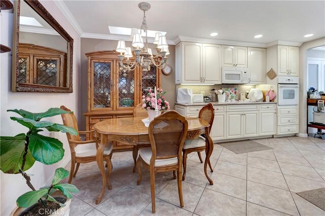 tiled dining area with a chandelier and ornamental molding