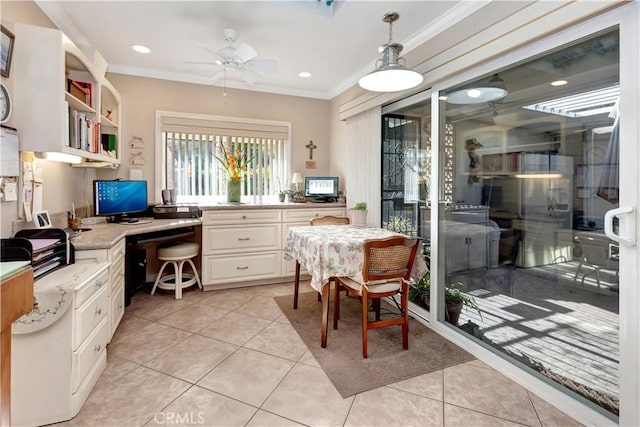 interior space featuring ceiling fan, ornamental molding, and built in desk