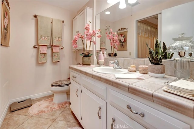 bathroom featuring toilet, vanity, and tile patterned flooring