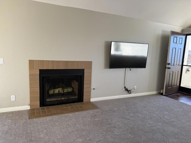 unfurnished living room with a fireplace and dark carpet