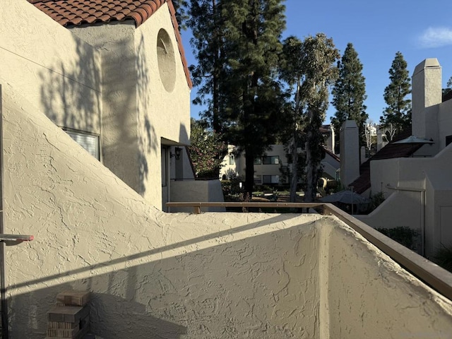 view of side of home with a balcony