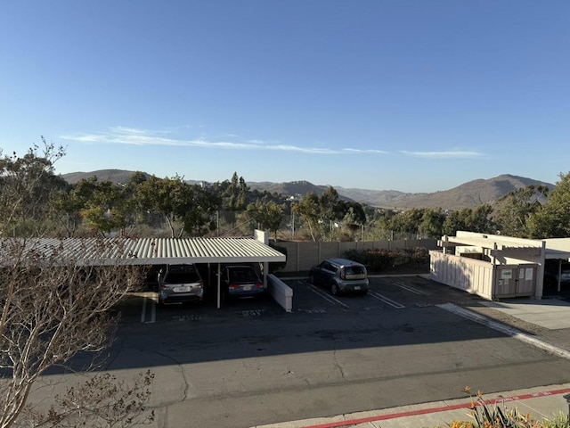 exterior space with a mountain view and a carport