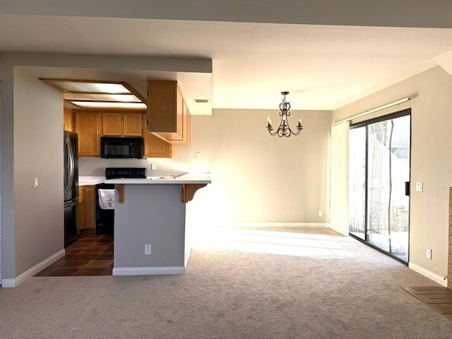 kitchen featuring black appliances, a kitchen bar, an inviting chandelier, dark colored carpet, and kitchen peninsula