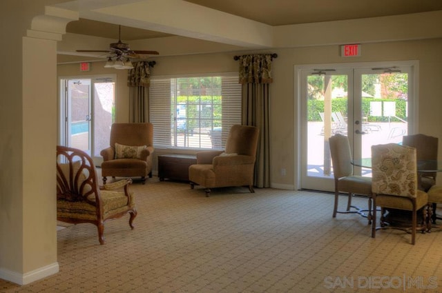 living area featuring ceiling fan, light colored carpet, a wealth of natural light, and french doors