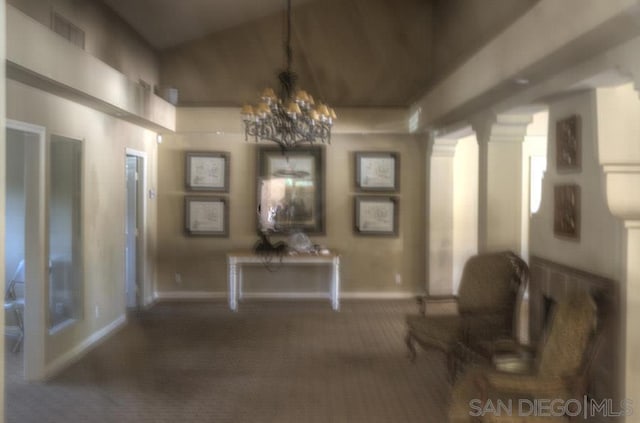 interior space featuring an inviting chandelier and decorative columns