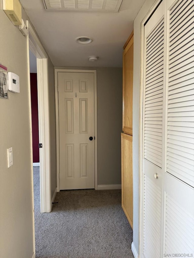 hallway featuring light colored carpet