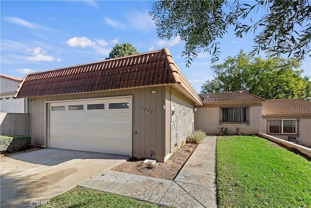 exterior space featuring a garage and a front lawn