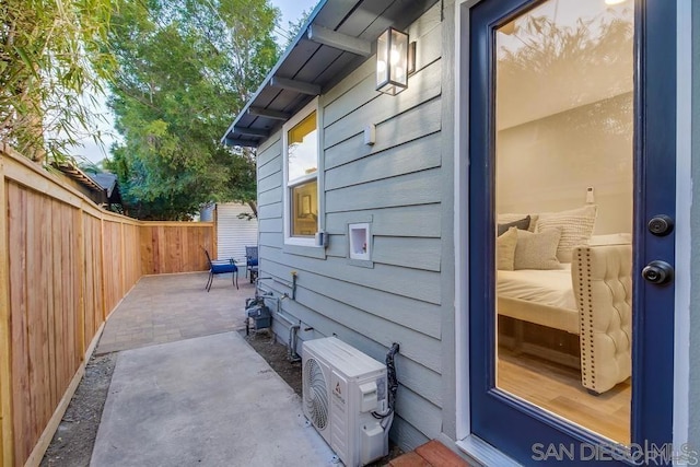 view of side of home with ac unit and a patio area