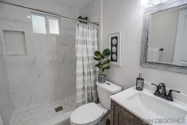 bathroom with toilet, vanity, and curtained shower