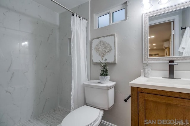 bathroom featuring toilet, walk in shower, and vanity