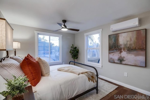 bedroom featuring an AC wall unit, dark hardwood / wood-style floors, and ceiling fan