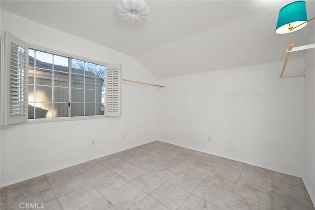 spare room featuring vaulted ceiling