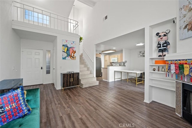 entrance foyer with a high ceiling and dark hardwood / wood-style floors