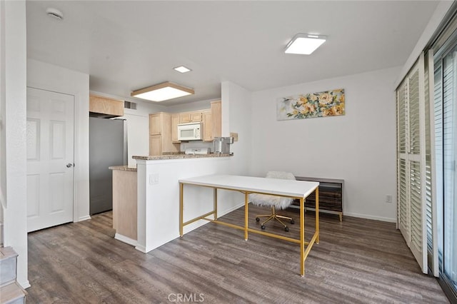 kitchen featuring light brown cabinetry, dark hardwood / wood-style flooring, kitchen peninsula, and stainless steel refrigerator