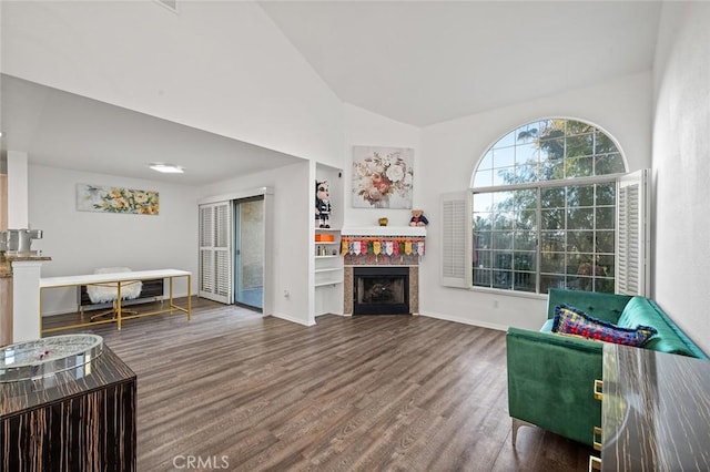 living room featuring dark hardwood / wood-style floors and vaulted ceiling