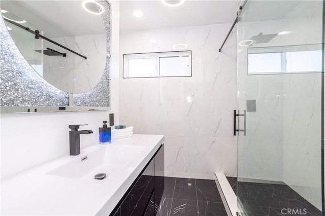 bathroom with a shower with door and vanity