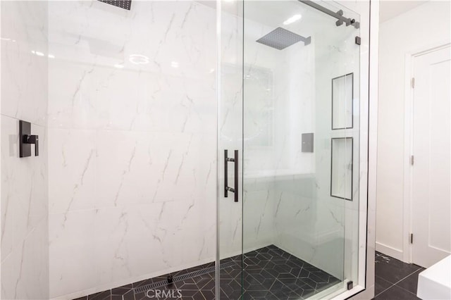 bathroom with a shower with shower door and tile patterned flooring