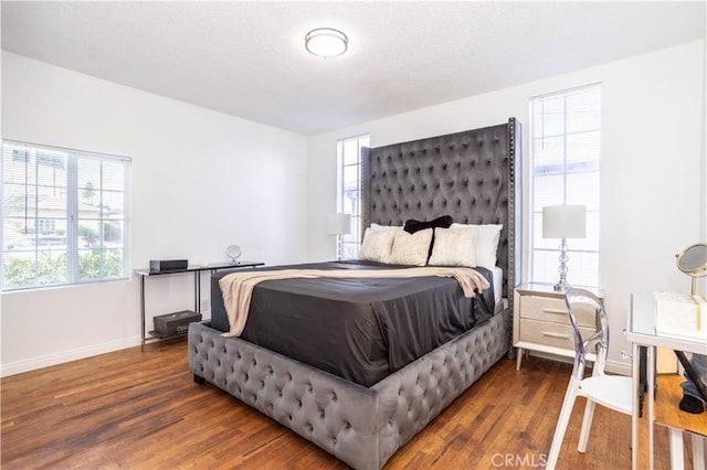 bedroom with dark wood-type flooring