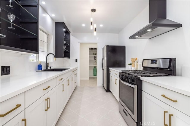 kitchen featuring sink, white cabinetry, hanging light fixtures, stainless steel appliances, and wall chimney exhaust hood