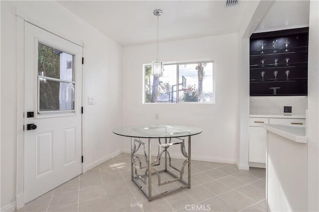 tiled dining space with a wealth of natural light