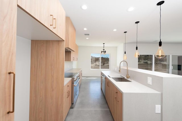 kitchen featuring light brown cabinetry, sink, hanging light fixtures, and appliances with stainless steel finishes