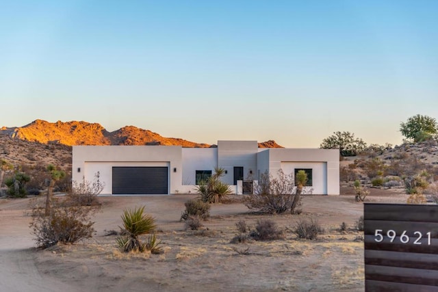 view of front of house with a mountain view and a garage