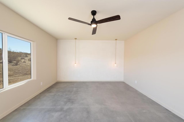 unfurnished room featuring ceiling fan and concrete flooring