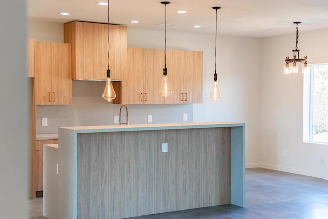 kitchen featuring light brown cabinetry, plenty of natural light, and concrete flooring