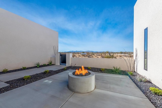 view of patio with a fire pit