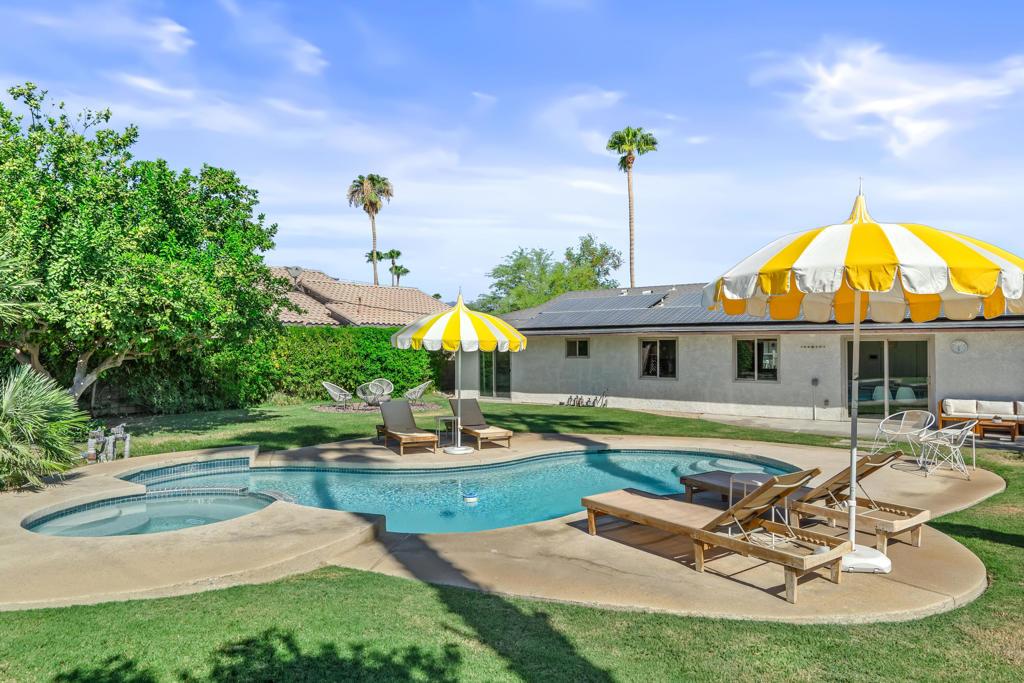 view of swimming pool with an in ground hot tub, a patio area, and a lawn