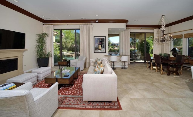 living room featuring crown molding and a chandelier