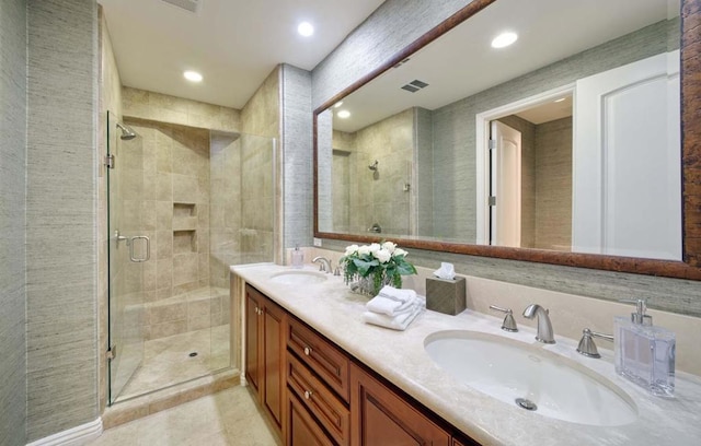 bathroom with vanity and a shower with shower door