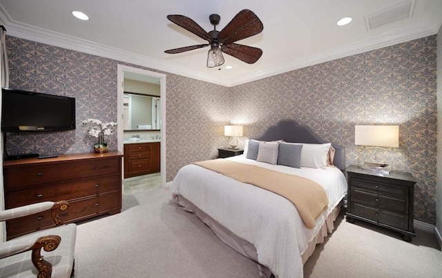 carpeted bedroom with ensuite bathroom, ceiling fan, and crown molding