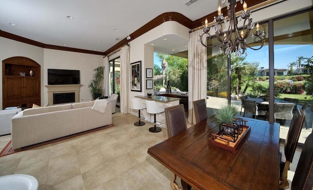 dining space featuring crown molding and a chandelier