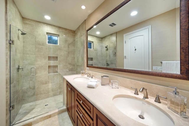 bathroom featuring vanity and a shower with shower door