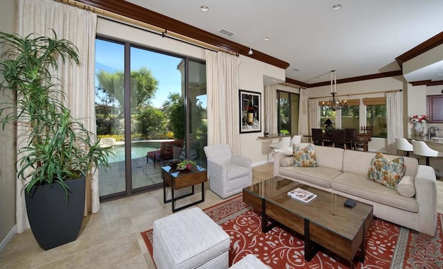 living room with crown molding and an inviting chandelier