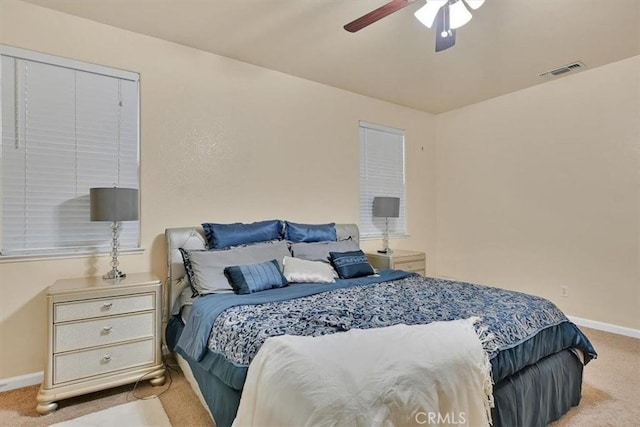 bedroom featuring ceiling fan, light carpet, and a closet