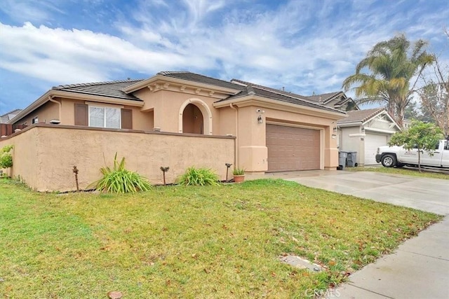 view of front of property with a front yard and a garage