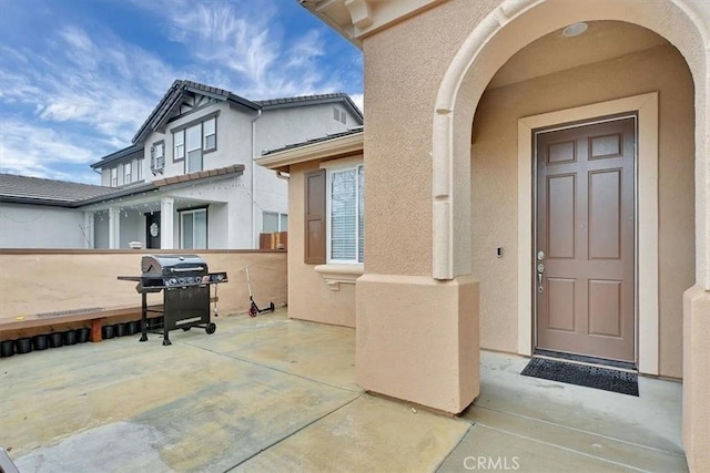 entrance to property with a patio