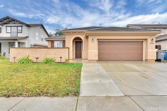 view of front of home with a front yard and a garage