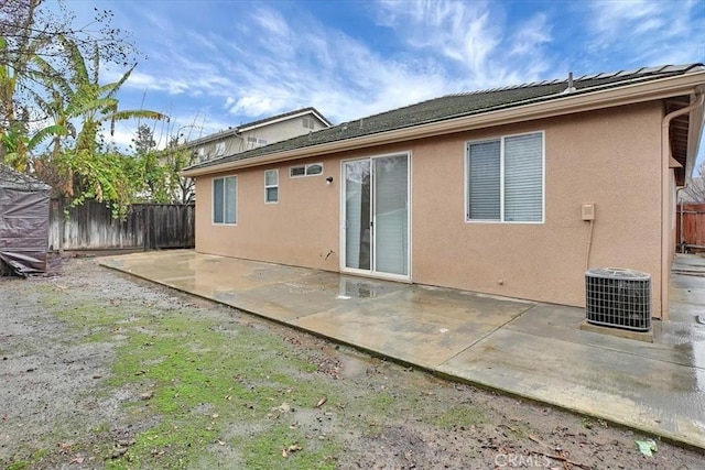 back of house with a patio area and central AC