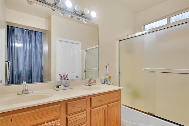 bathroom with combined bath / shower with glass door and vanity