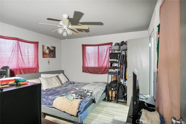 bedroom with ceiling fan and light hardwood / wood-style flooring