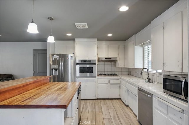 kitchen with appliances with stainless steel finishes and white cabinets