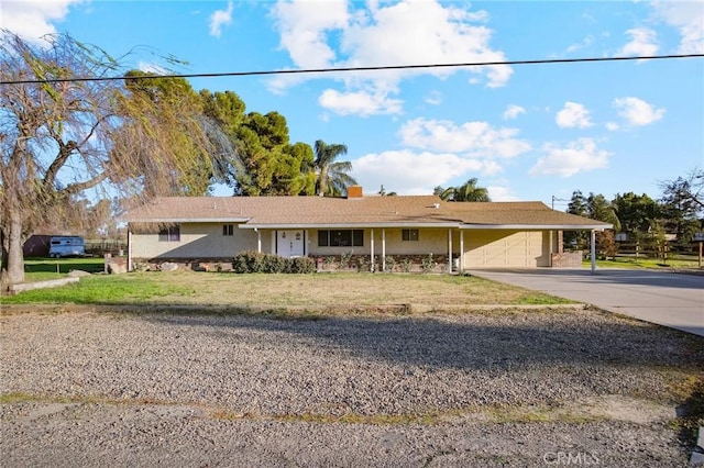 ranch-style home featuring a garage and a front yard