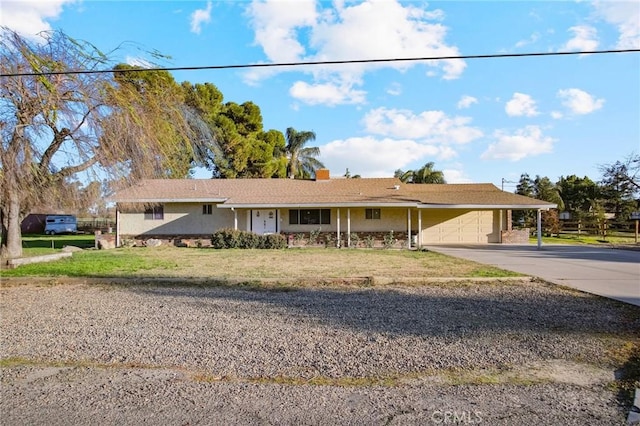 ranch-style house featuring a garage and a front yard