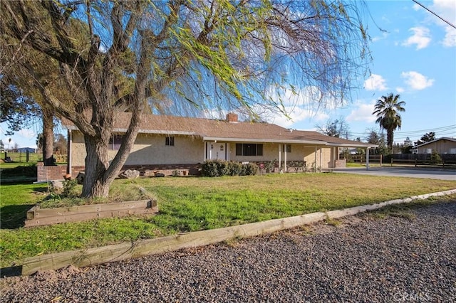 view of front of house with a front lawn and a carport